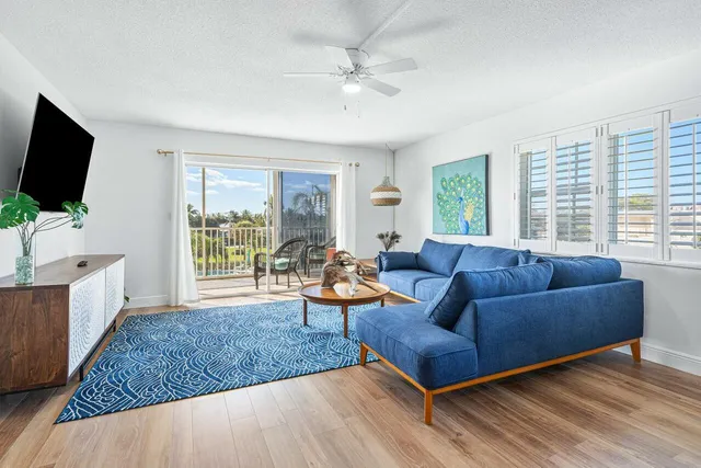 a dining room with wooden floor and window