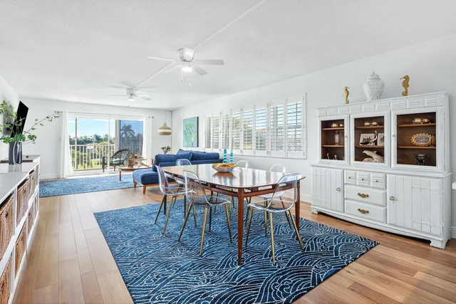 a kitchen with white cabinets and refrigerator