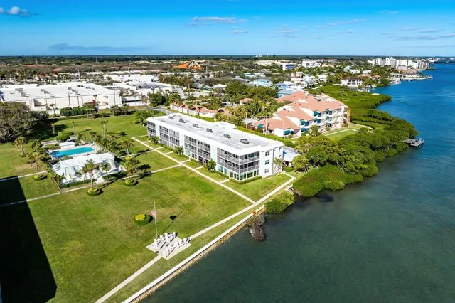 an aerial view of a pool with a yard