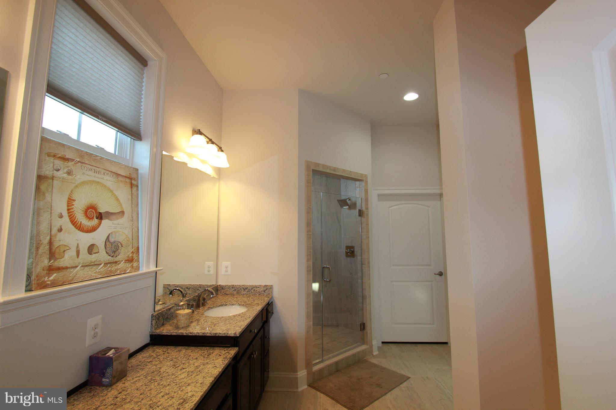 2972 Levee Drive Odenton, MD 21113 - Photo 11 of 30 a bathroom with a granite countertop sink and a mirror