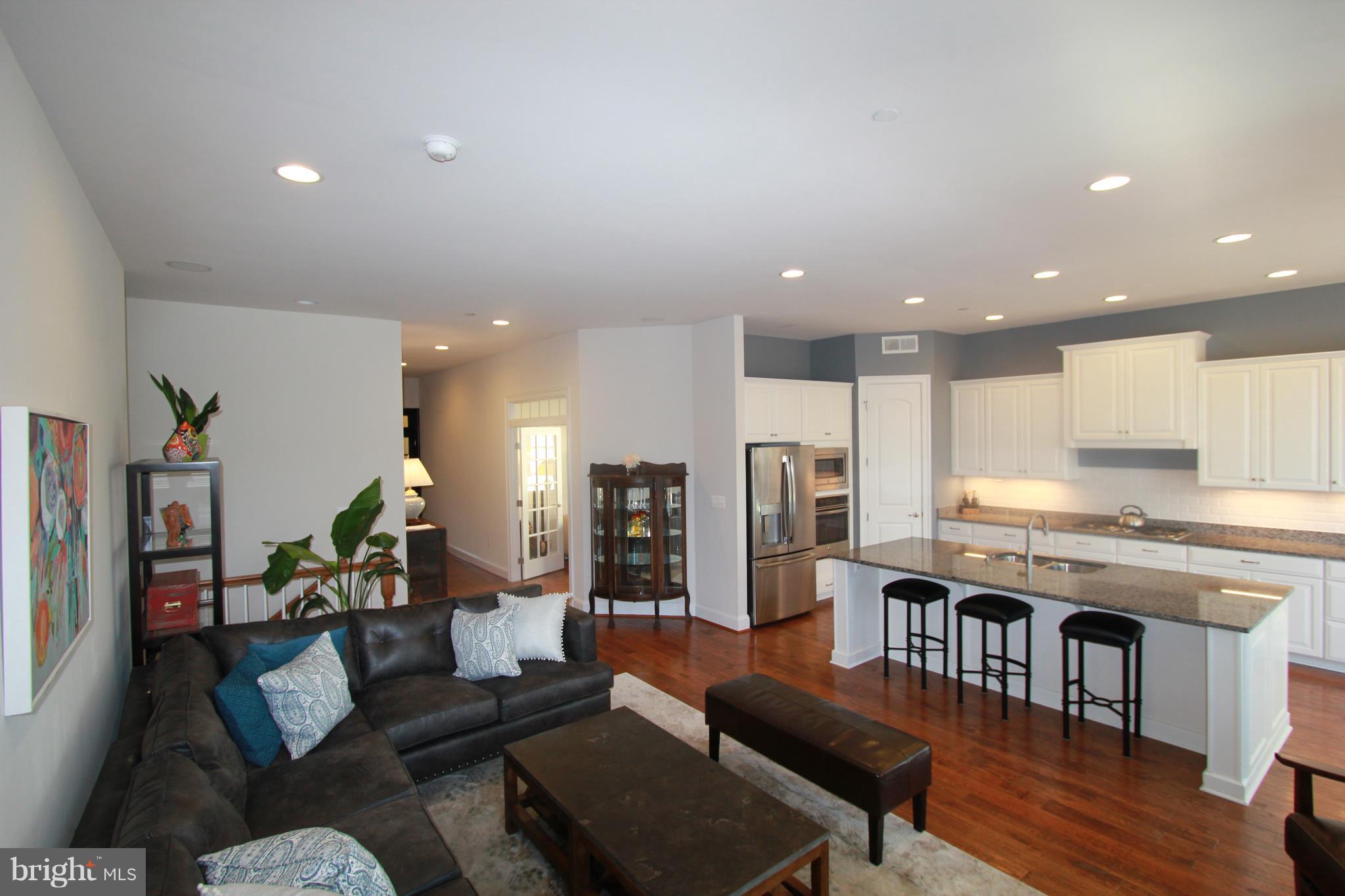 2972 Levee Drive Odenton, MD 21113 - Photo 4 of 30 a living room with stainless steel appliances kitchen island granite countertop furniture and a kitchen view