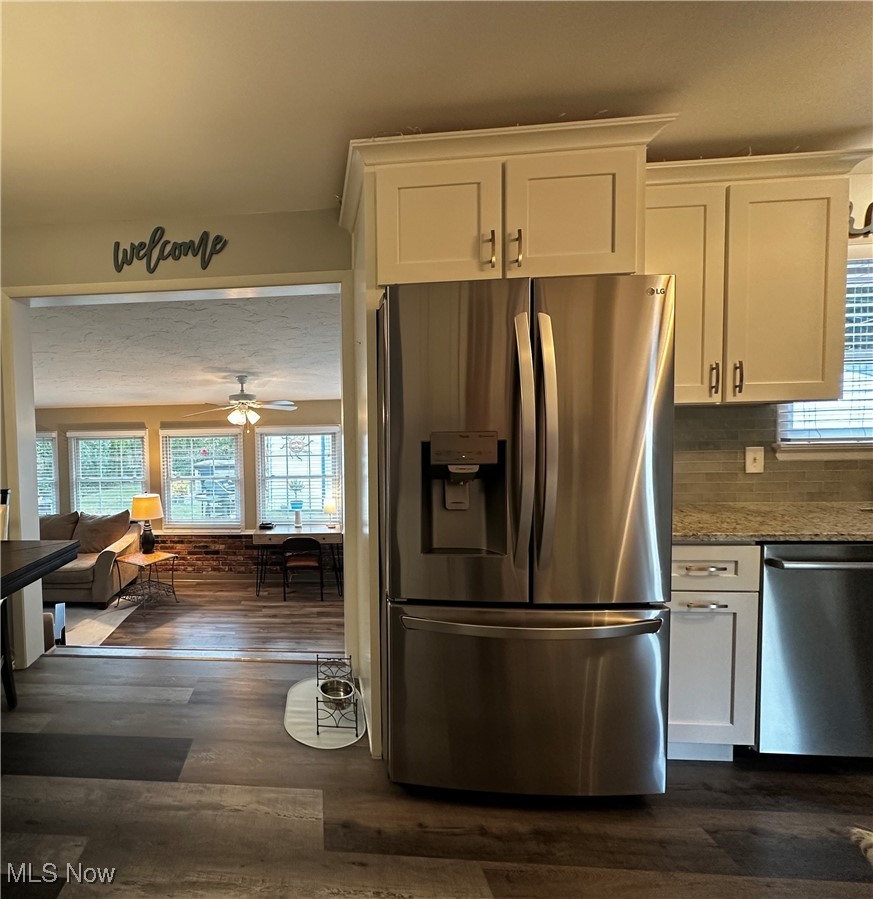 739 Sterling Road Wickliffe, OH 44092 - Photo 5 of 27 Kitchen with white cabinets, light stone countertops, stainless steel appliances, dark hardwood / wood-style floors, and ceiling fan