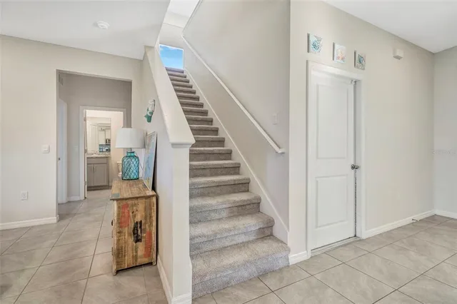 an empty room with window and ceiling fan