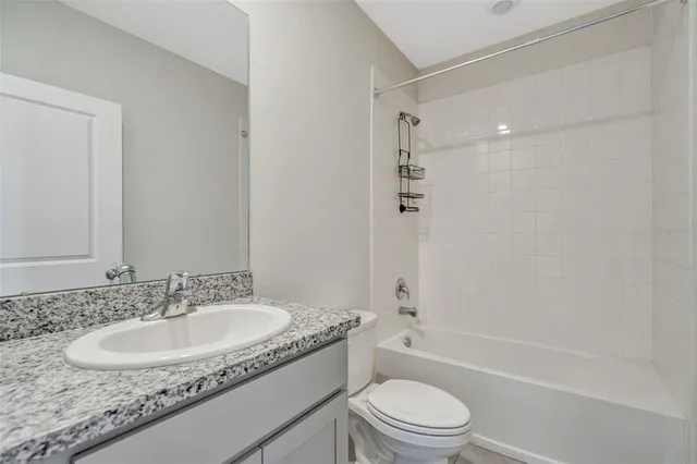 a view of a livingroom with a ceiling fan and window