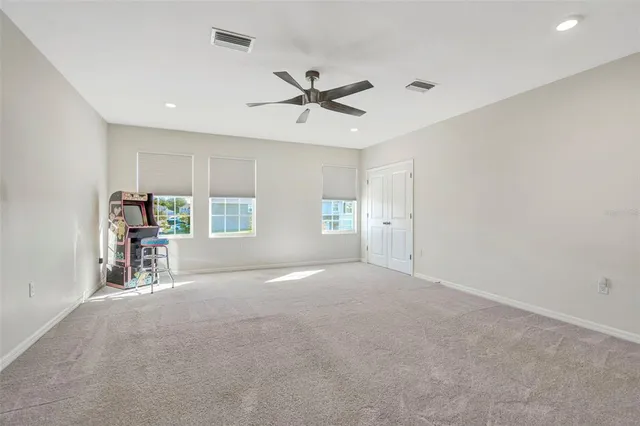 a view of an empty room with a ceiling fan
