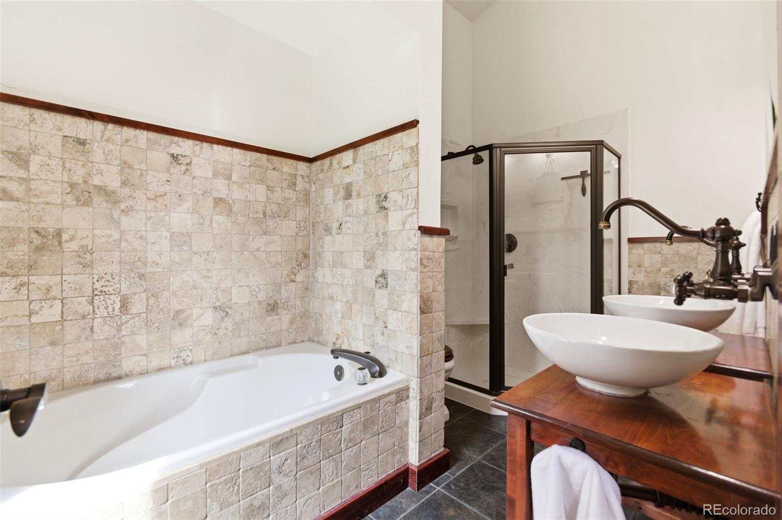 202 Badger Lane Bailey, CO 80421 - Photo 22 of 50 a bathroom with a bathtub shower sink mirror and toilet