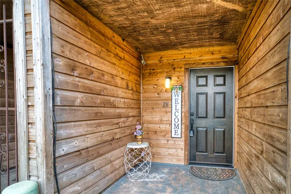a view of a wooden door and brick wall