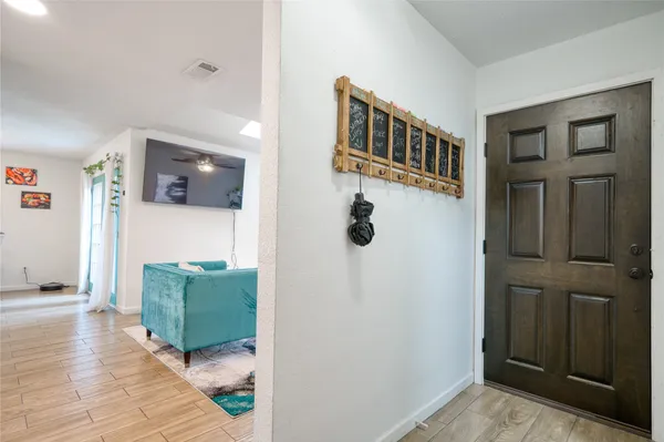 a view of a hallway with windows and entryway