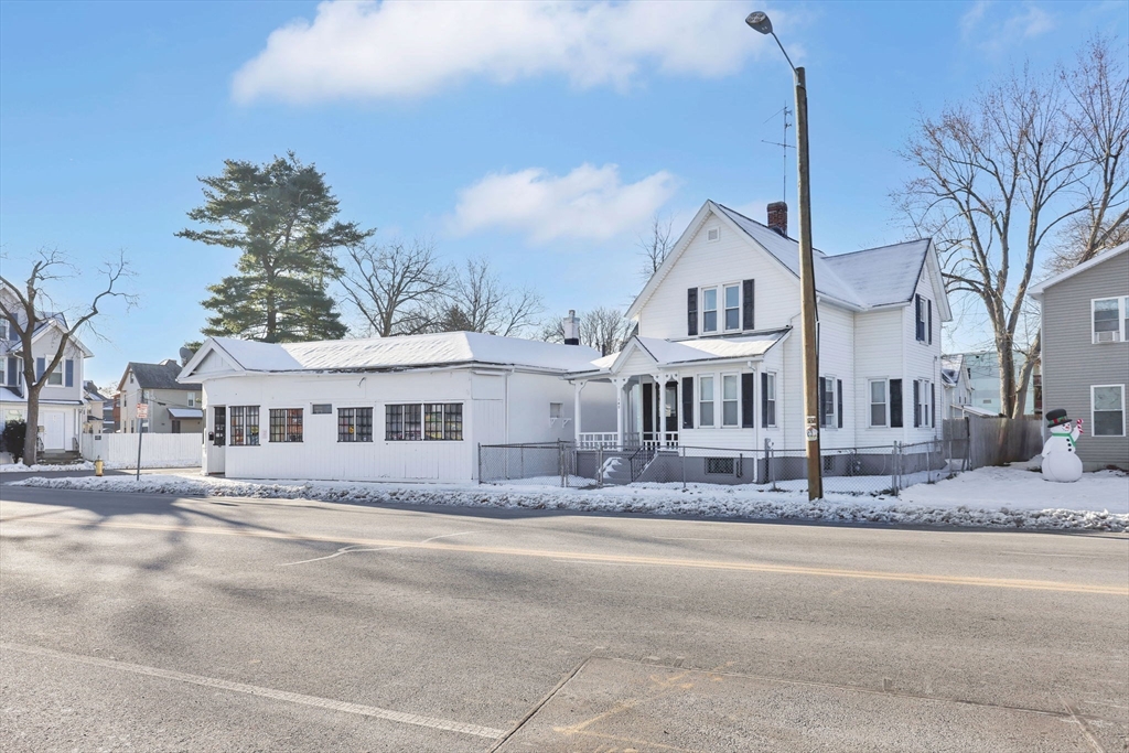 a front view of a house with a dirt yard