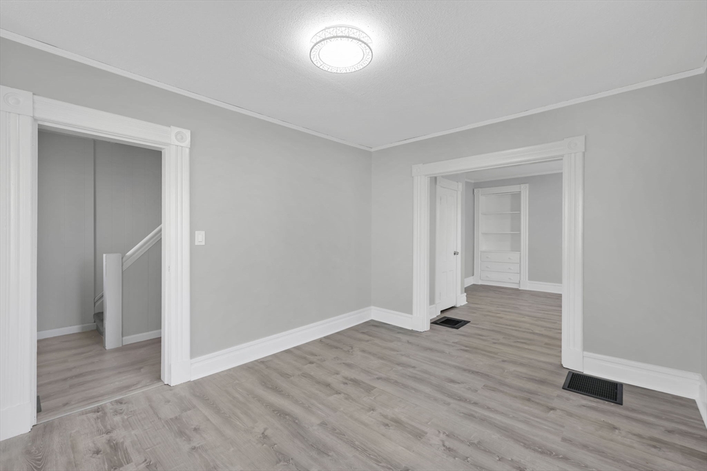140-142 Dickinson Street Springfield, MA 01108 - Photo 13 of 42 an empty room with wooden floor and entrance