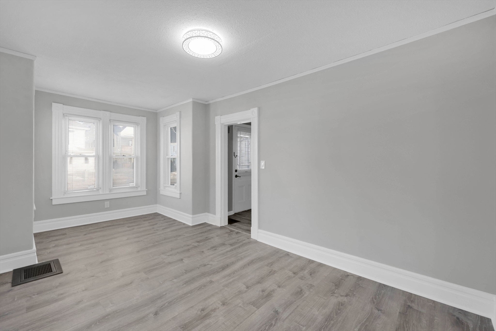 140-142 Dickinson Street Springfield, MA 01108 - Photo 14 of 42 an empty room with wooden floor and windows