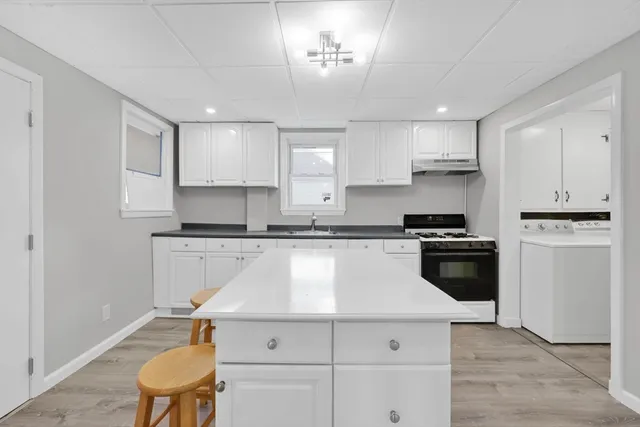 a kitchen with stainless steel appliances granite countertop a stove and a sink