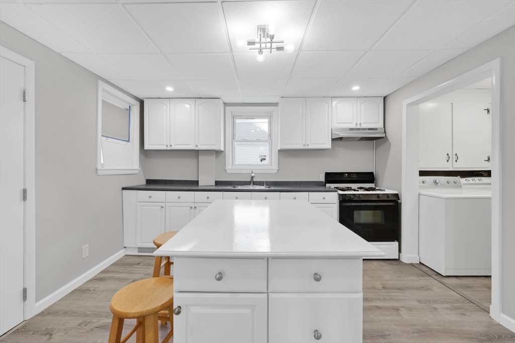 140-142 Dickinson Street Springfield, MA 01108 - Photo 21 of 42 a kitchen with a white cabinets and white appliances
