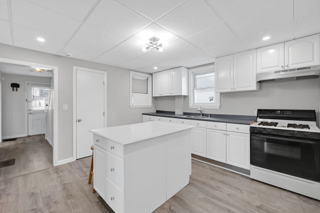 140-142 Dickinson Street Springfield, MA 01108 - Photo 22 of 42 a kitchen with stainless steel appliances granite countertop a stove and a sink