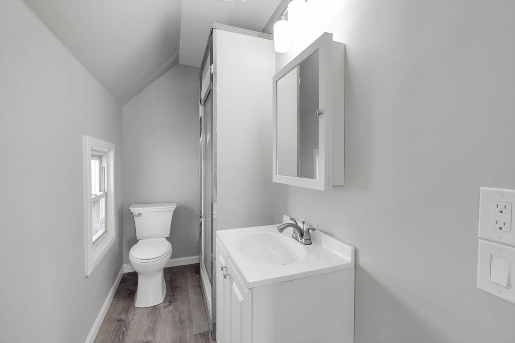 140-142 Dickinson Street Springfield, MA 01108 - Photo 29 of 42 a bathroom with a toilet sink and mirror