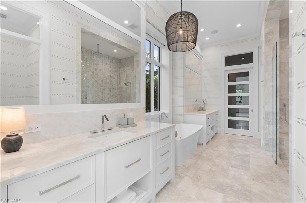 4511 Crayton Road Naples, FL 34103 - Photo 11 of 28 a spacious en suite bathroom with double sink and a mirror