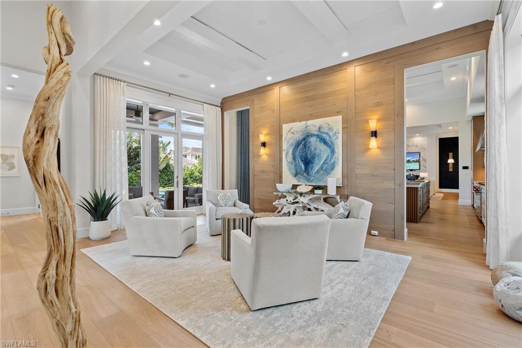 4511 Crayton Road Naples, FL 34103 - Photo 13 of 28 a living room with furniture a large window and wooden floor