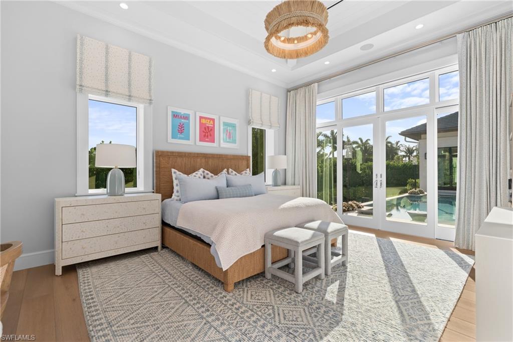 4511 Crayton Road Naples, FL 34103 - Photo 15 of 28 a spacious bedroom with a bed and a large window