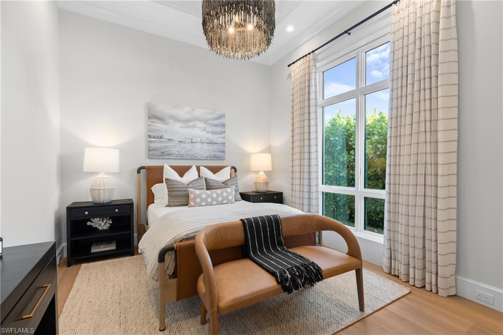 4511 Crayton Road Naples, FL 34103 - Photo 17 of 28 a bedroom with a large bed and a window