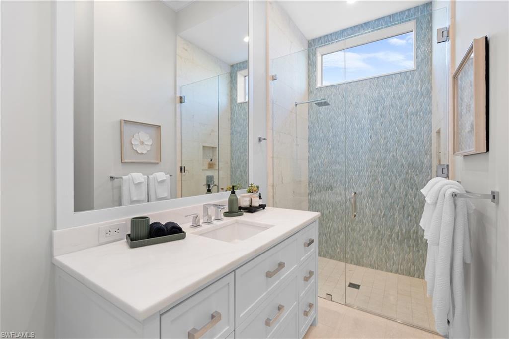 4511 Crayton Road Naples, FL 34103 - Photo 20 of 28 a bathroom with a sink a toilet and shower