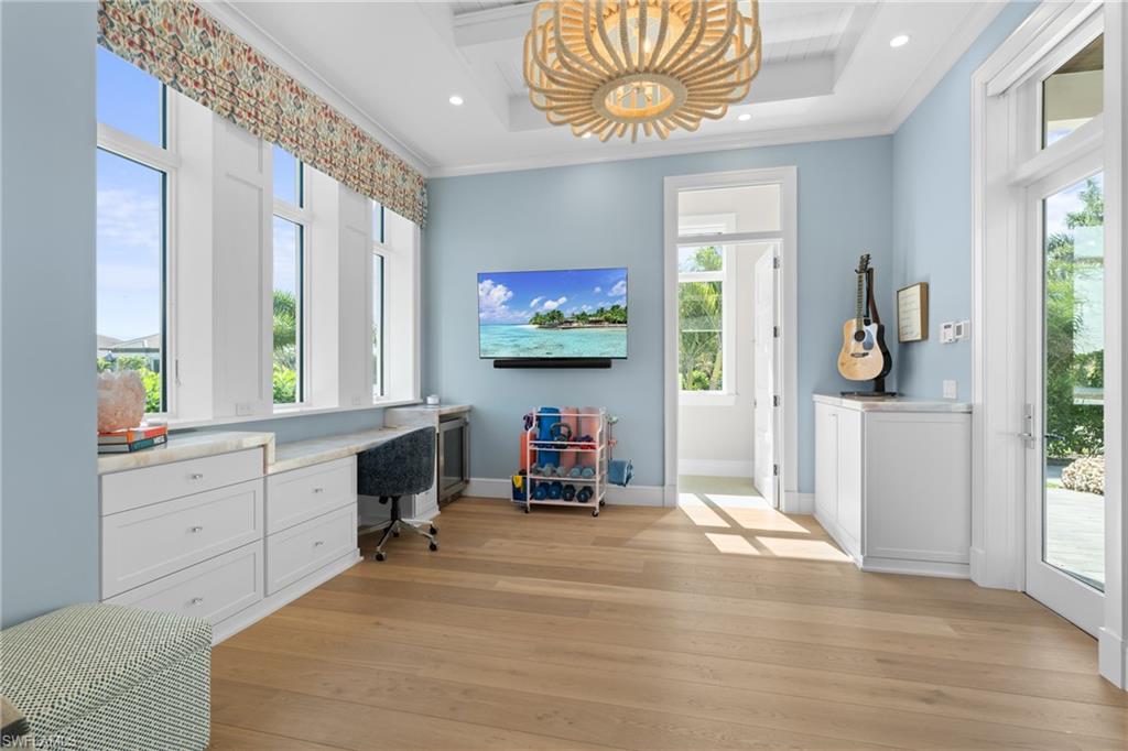 4511 Crayton Road Naples, FL 34103 - Photo 21 of 28 a living room with furniture and a flat screen tv