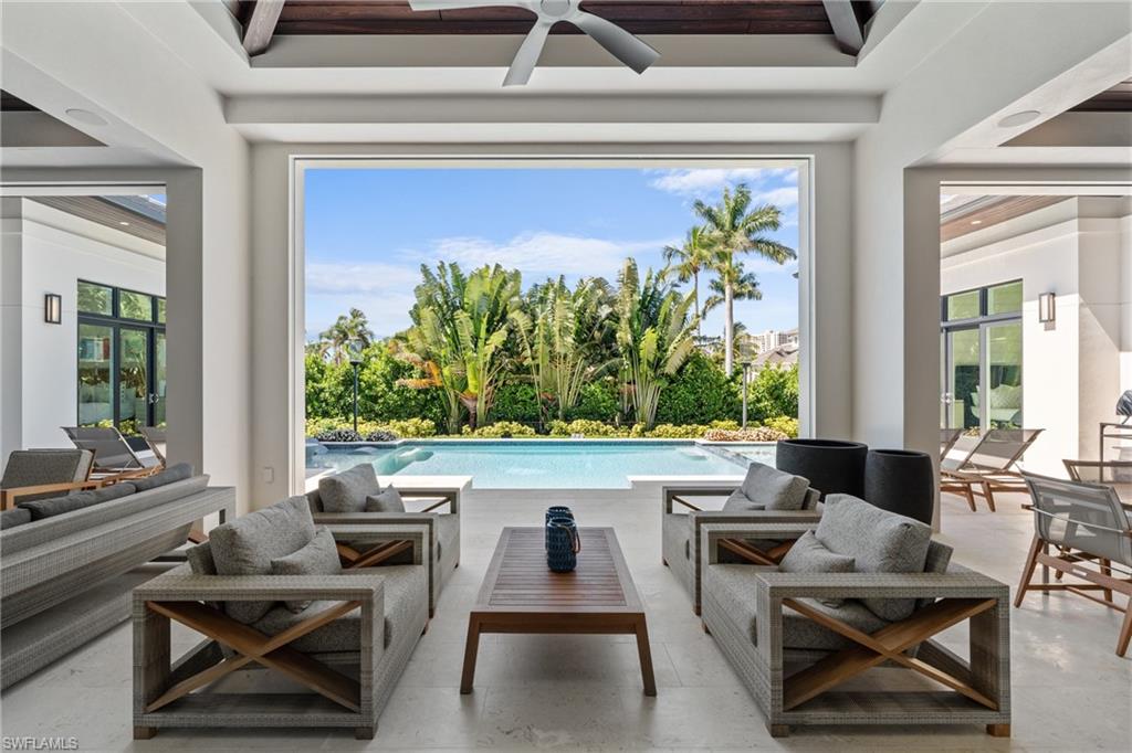 4511 Crayton Road Naples, FL 34103 - Photo 24 of 28 a living room with furniture and a potted plant
