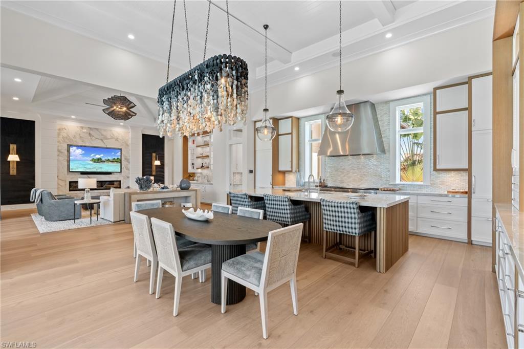 4511 Crayton Road Naples, FL 34103 - Photo 3 of 28 a kitchen with a table and chairs in it