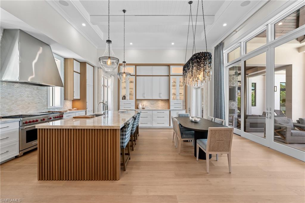 4511 Crayton Road Naples, FL 34103 - Photo 5 of 28 a kitchen with lots of counter top space and a wooden floor