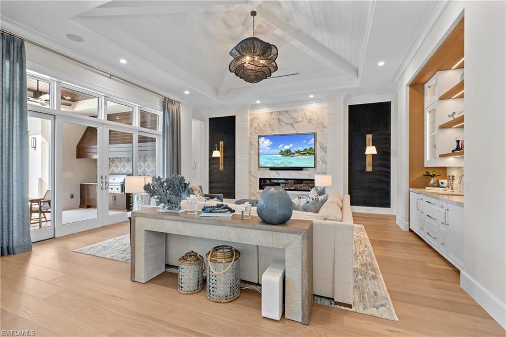 4511 Crayton Road Naples, FL 34103 - Photo 8 of 28 a dining room with furniture and wooden floor