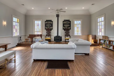 a living room with furniture and wooden floor