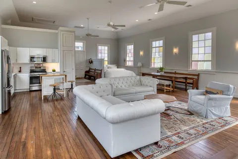 a living room with furniture and wooden floor
