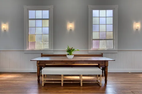 a view of a workspace with furniture and window