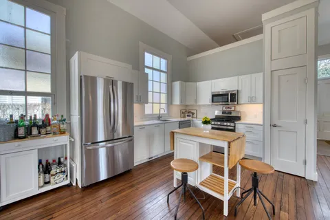 a kitchen with white cabinets and stainless steel appliances