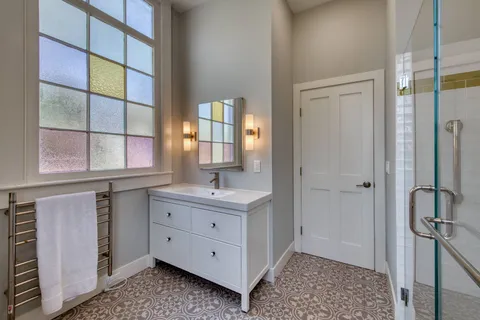 a bathroom with a sink a mirror and a window