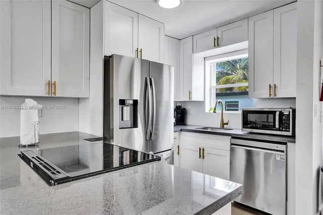 a living room with furniture kitchen view and a window
