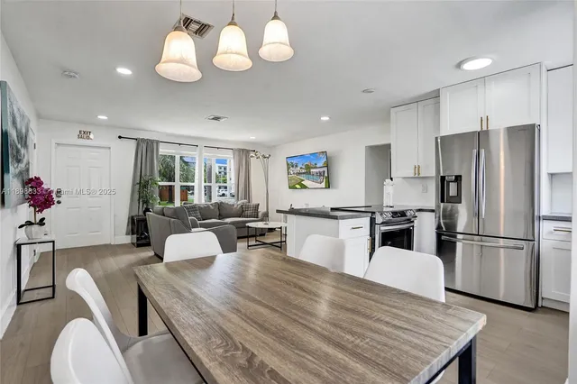 a living room with furniture and a air conditioner vent
