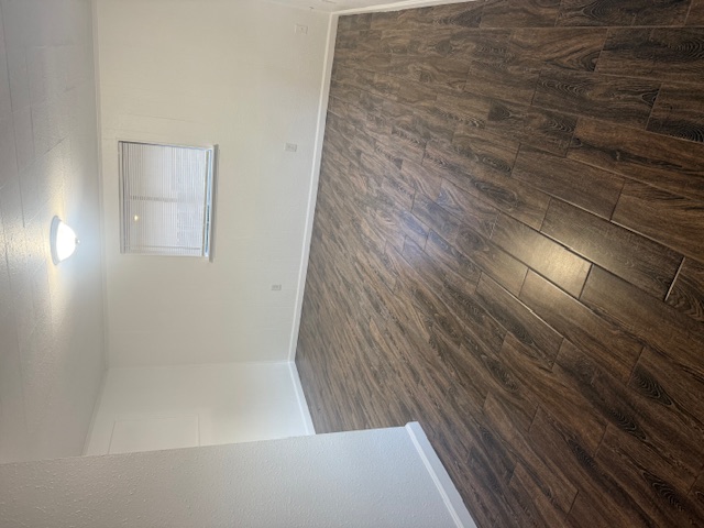 417 South Commerce Street, Unit B Lockhart, TX 78644 - Photo 6 of 9 Empty room with dark wood finished floors