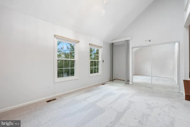 an empty room with a empty space and windows