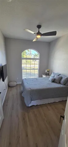 a bedroom with a bed and a large window