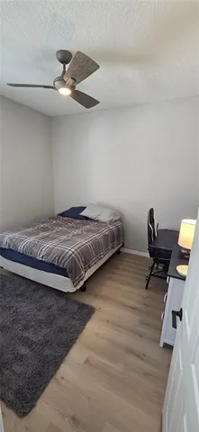 a bedroom with a bed and a desk