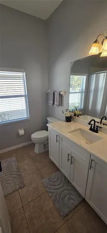 a bathroom with a sink toilet and window