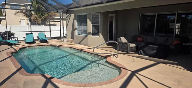 a backyard of a house with table and chairs