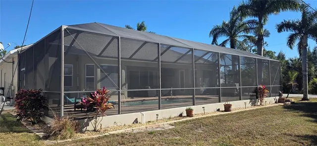 a view of a two chair and tables in the back yard of the house