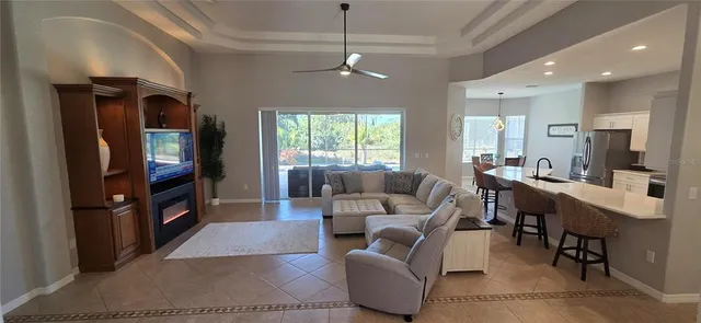 a living room with furniture a window and a flat screen tv