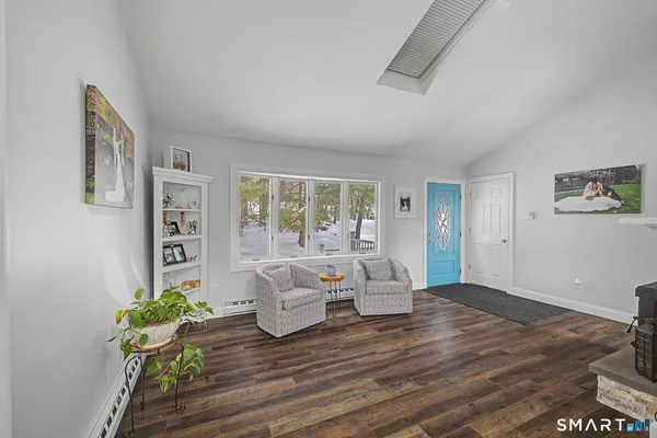 a living room with furniture and wooden floor