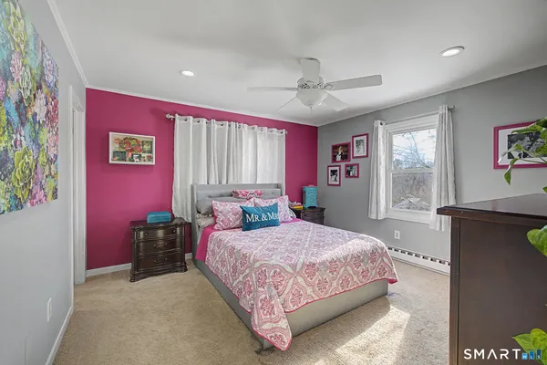 a bedroom with a bed and a dresser