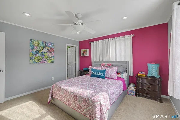 a bedroom with a large bed and a chandelier
