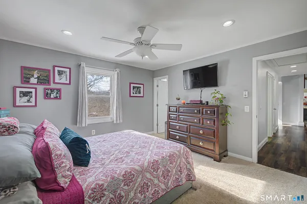 a bedroom with a bed and a television