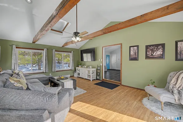 a bedroom with furniture and a large window