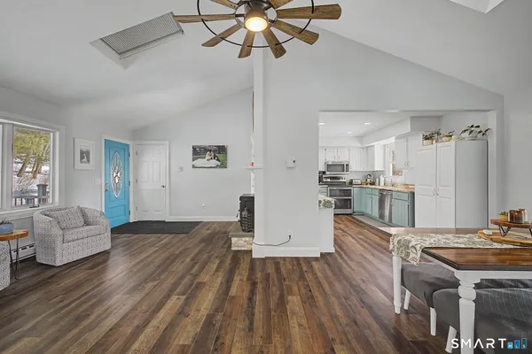 a living room with furniture and kitchen view